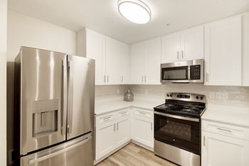 A kitchen with a stainless steel refrigerator and oven at The Azul Apartment Homes in Oxford, MS