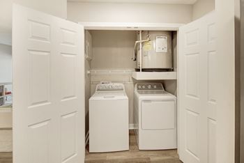 A laundry room with a washer and dryer in it at Azul Apartment Homes in Oxford, MS