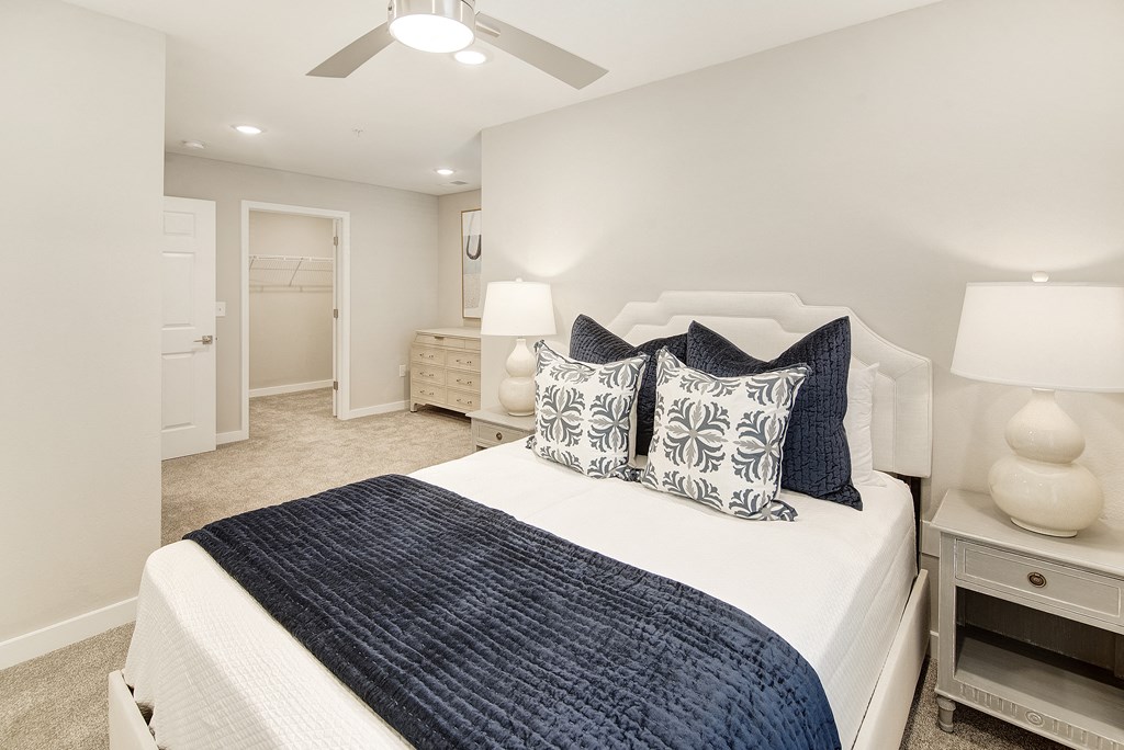 a bedroom with a large bed and a ceiling fan at The Azul Apartment Homes, Oxford, Mississippi