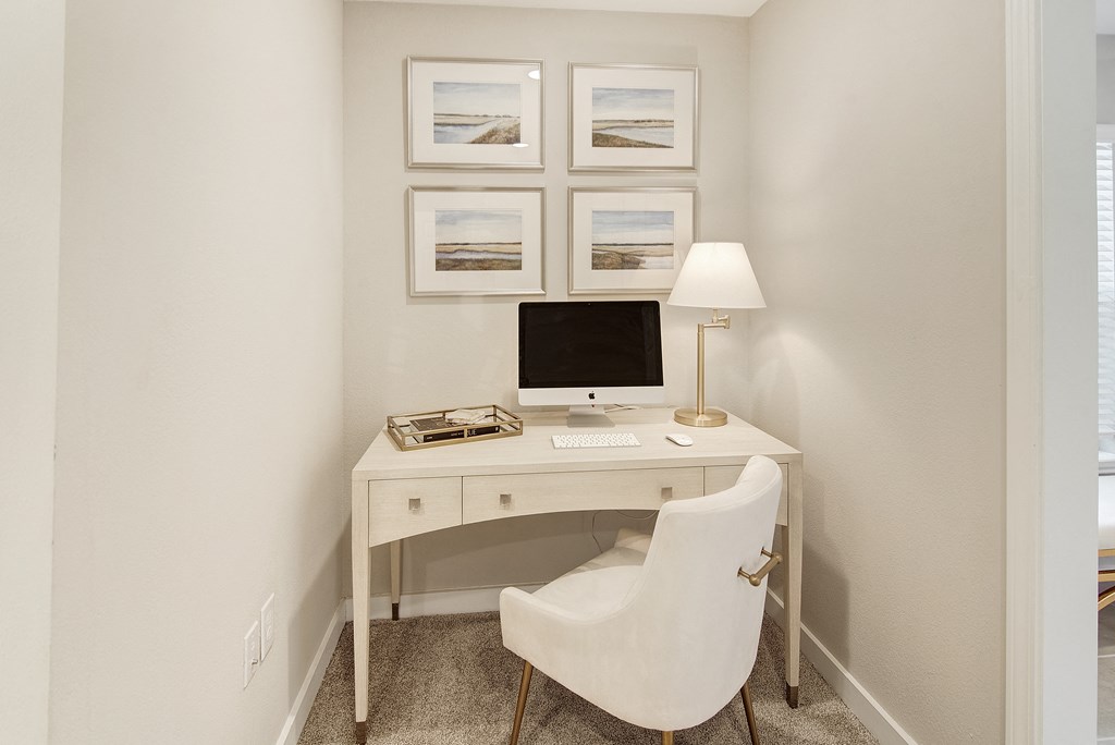 a home office with a computer desk and a white chair at The Azul Apartment Homes in Mississippi 38655