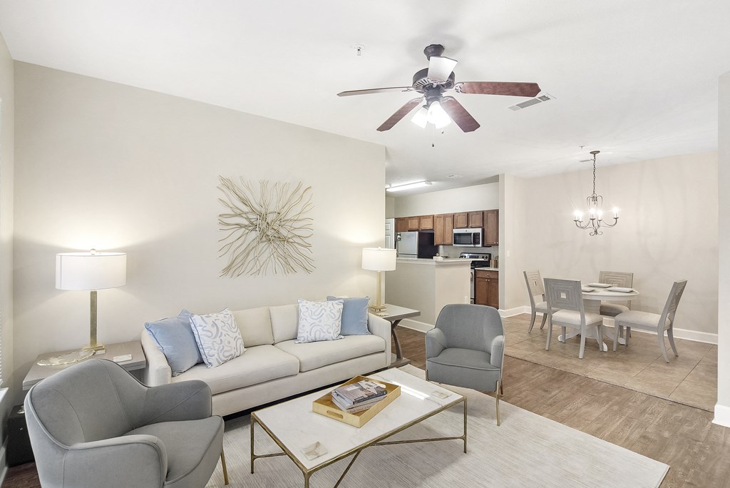 Living room with a couch and a ceiling fan at Highlands Apartment Homes, Bartlett, Tennessee