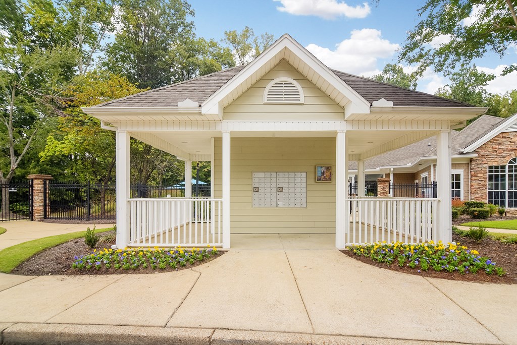 Front porch of a yellow house with a porch swing at Highlands Apartment Homes, Tennessee , 38135