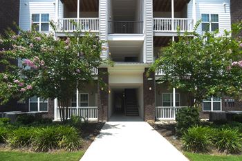 the sidewalk in front of an apartment building at The Met Apartment Homes in Hattiesburg, Mississippi 39402 at The Met Apartment Homes in MS 39402