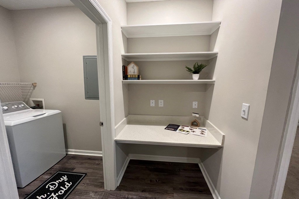 a utility room with shelves and a sink and a washer and dryer at Carlton Park Apartment Homes, Flowood, MS, 39232