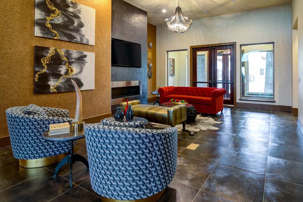 a living room with a couch and tables and a television at The Retreat Apartment Homes in Williston, ND 58801