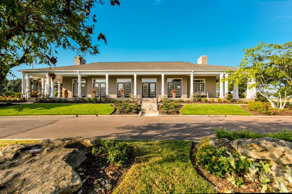 a house with a driveway and a tree in front of it  at Highpointe Apartment Homes, Brandon, MS, 39042