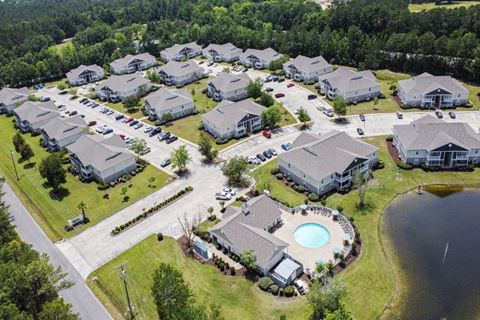 an aerial view of a subdivision with houses and a swimming pool