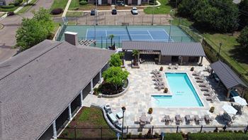 Aerial view of tennis court  by a pool at Highpointe Apartment Homes, Brandon, Mississippi