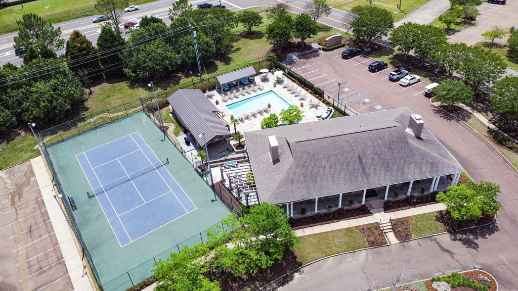 an aerial view of a tennis court and a building with a pool at Highpointe Apartment Homes, Brandon, 39042