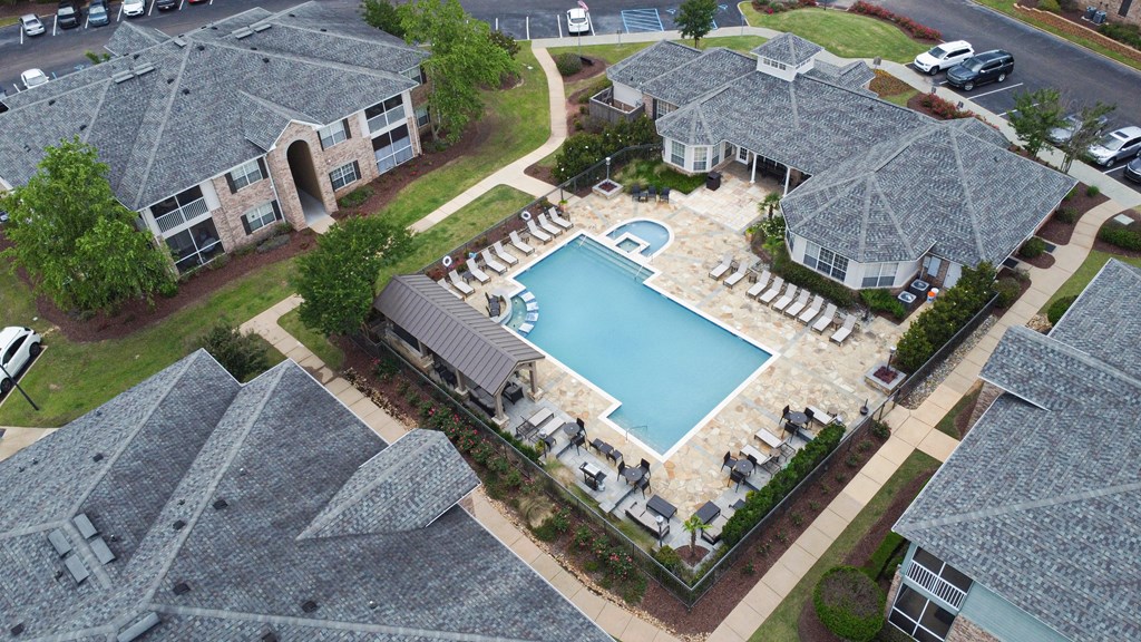 an aerial view of a swimming pool in a home with umbrellas at Ashford Place Apartment Homes, Flowood