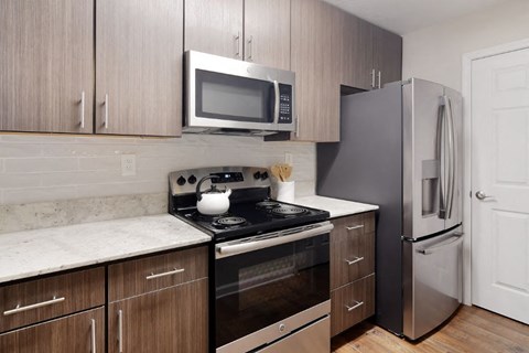 a kitchen with a stove refrigerator and microwave  at Bridgewater Apartment Homes, Brandon