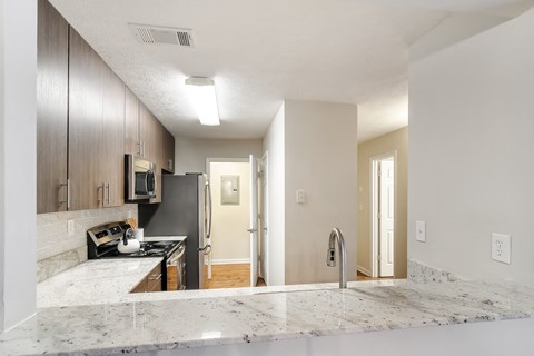 a kitchen with granite counter tops and a stove and refrigerator at Bridgewater Apartment Homes, Brandon, Mississippi