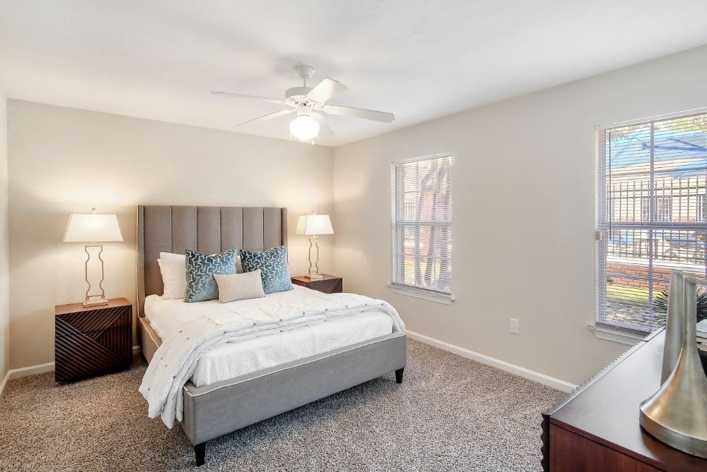 a bedroom with a bed and two windows  at Bridgewater Apartment Homes, Brandon, 39047