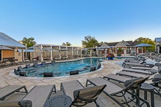 a resort style pool with lounge chairs around it