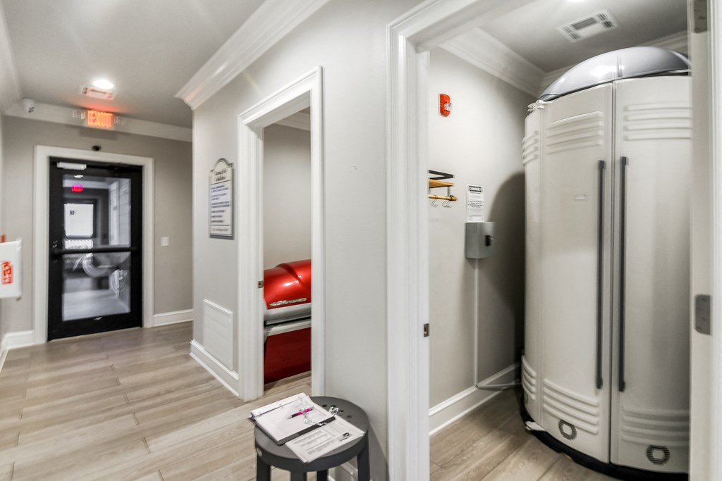 a room with two refrigerators and a door to a bedroom at Crossgates Apartment Homes, Starkville, 39759