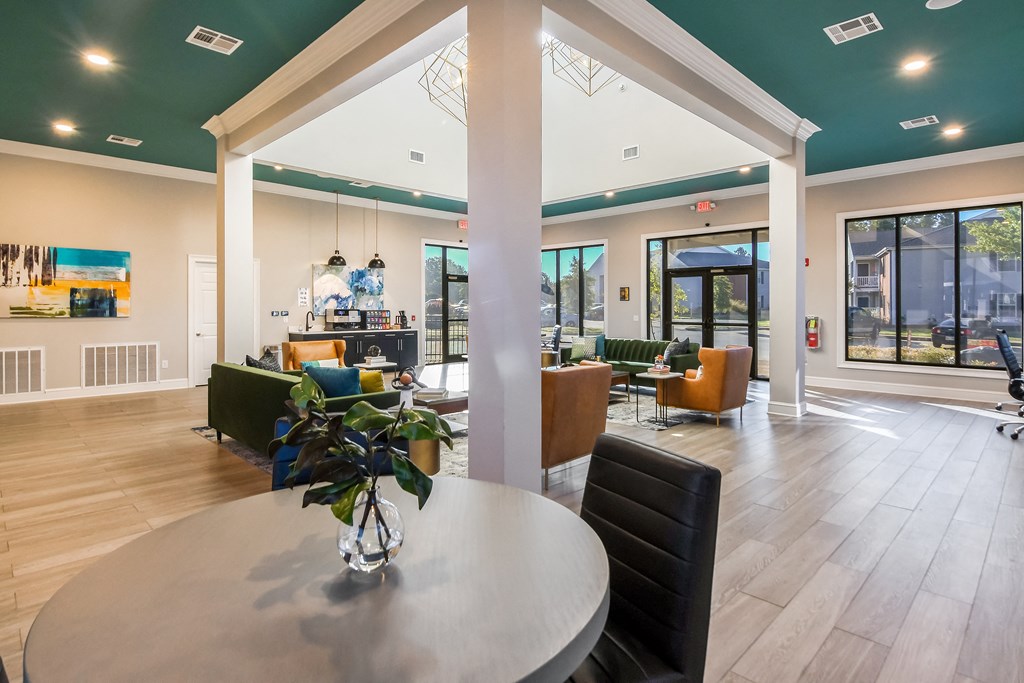 the preserve at ballantyne commons clubhouse with a round dining table and a bar at Crossgates Apartment Homes, Mississippi