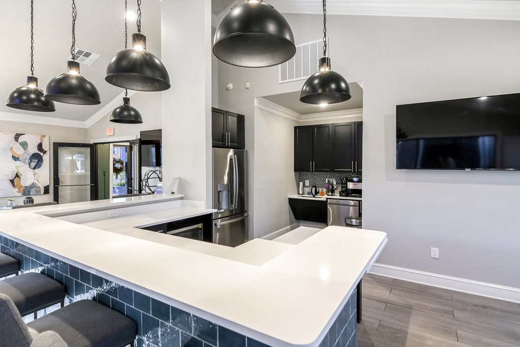 a kitchen with a long island with a white counter top at Crossgates Apartment Homes, Starkville, 39759