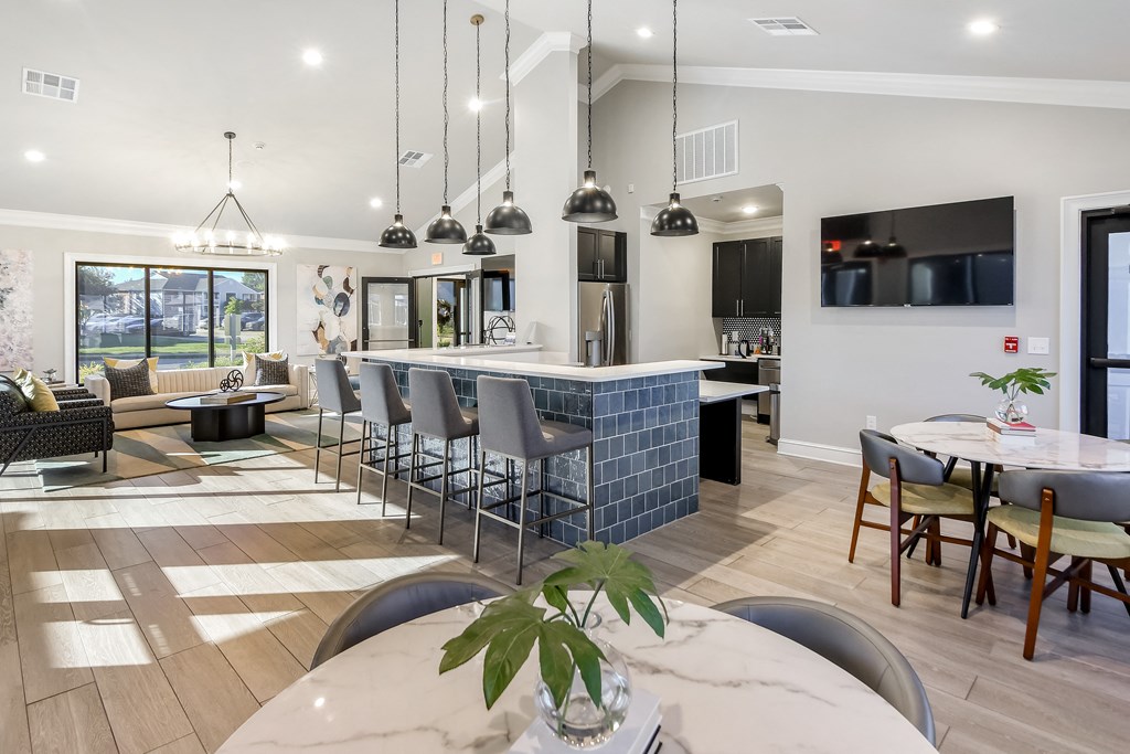 an open floor plan with a kitchen and dining area and a living room at Crossgates Apartment Homes, Starkville, MS