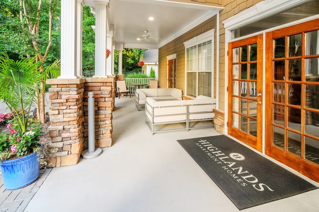 A patio area with a Highlands sign on the mat.