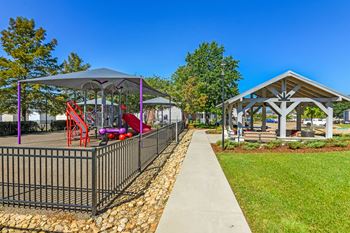A playground with a slide and a gazebo at Crossgates Apartment Homes, Mississippi 39759