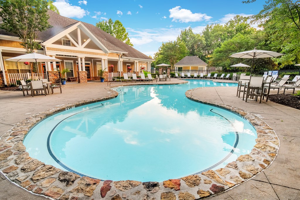 A large swimming pool surrounded by a stone border.