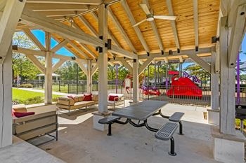 Outdoor lounge and picnic tables at Crossgates Apartment Homes, Starkville, 39759