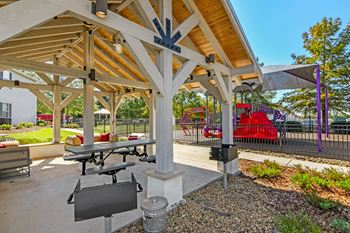 Lounge and grill by the playground at Crossgates Apartment Homes, Starkville, Mississippi