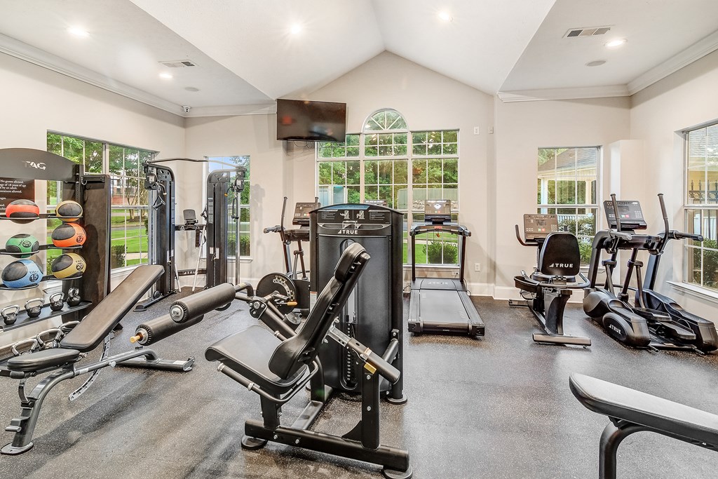 A spacious home gym with a variety of exercise equipment.
