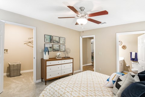 a bedroom with a large bed and a ceiling fan at Crossgates Apartment Homes, Starkville, MS 39759