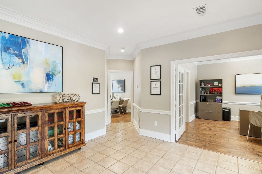 a living room with a large painting on the wall and a tiled floor at The Colony Apartment Homes, Columbus, 39702
