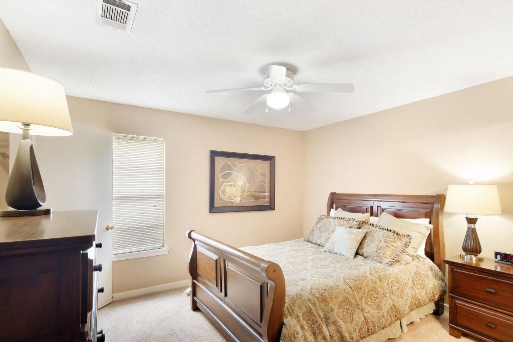 a bedroom with a bed and a ceiling fan at The Colony Apartment Homes, Mississippi