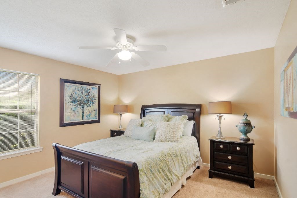 a bedroom with a bed and two night stands at The Colony Apartment Homes, Columbus, MS, 39702