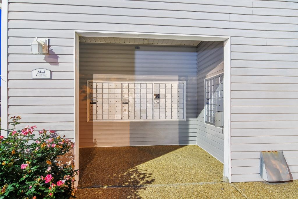 a garage with a door open and a collection of lockers in the door at The Colony Apartment Homes, Columbus