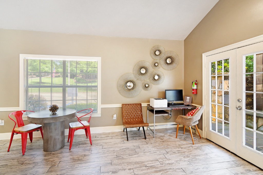 a living room with a table and chairs and a tv