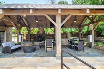 A patio with a fireplace and chairs Lexington Pointe Apartment Homes in Oxford, Mississippi