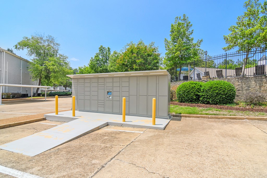 a small building with yellow poles in a parking lot at Lexington Pointe Apartment Homes in Oxford, Mississippi 38655