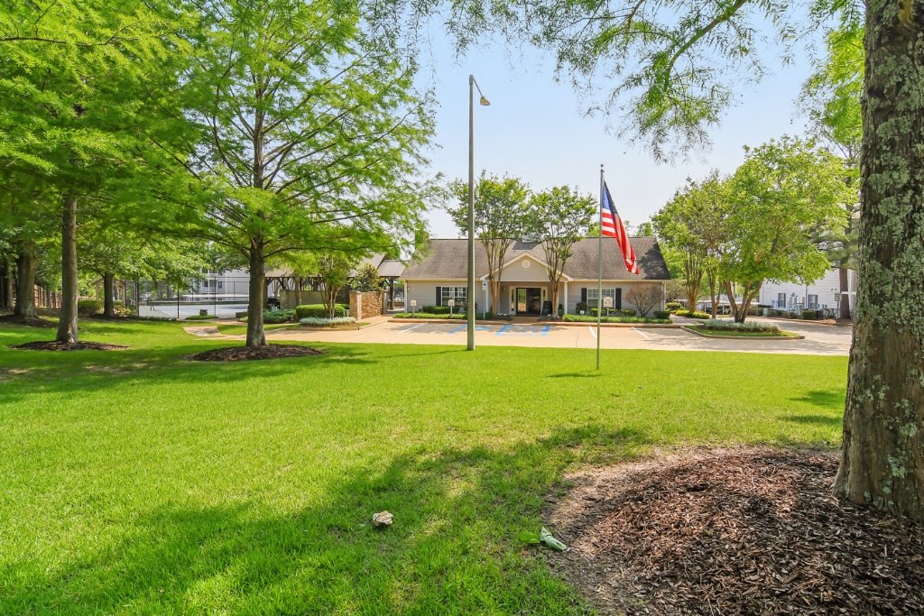 a flagpole with an american flag in front of a house at Lexington Pointe Apartment Homes, Oxford, 38655