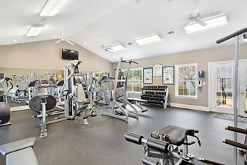 A spacious gym with a variety of equipment including treadmills, weights, and exercise machines Lexington Pointe Apartment Homes in Oxford, MS 38655