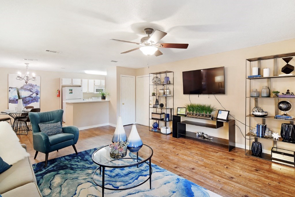 a living room with a ceiling fan and a flat screen tv at Lexington Pointe Apartment Homes, Mississippi, 38655