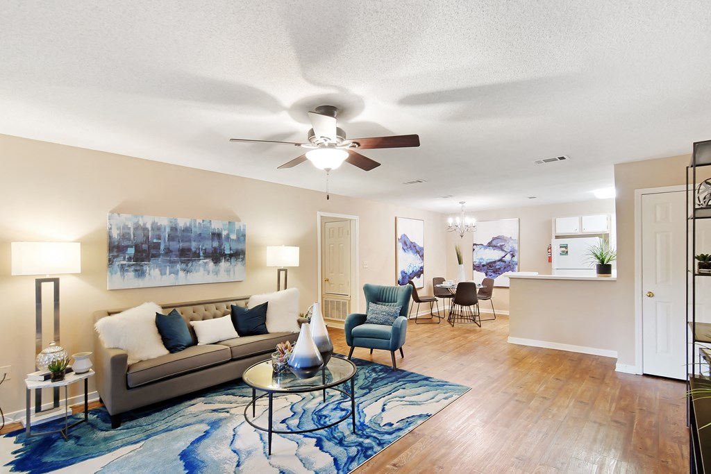 a living room with a couch and a ceiling fan at Lexington Pointe Apartment Homes in Oxford, MS 