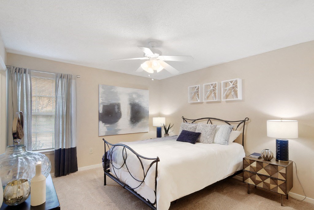 a bedroom with a bed and a ceiling fan at Lexington Pointe Apartment Homes, Oxford