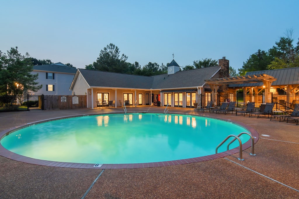 a swimming pool with a house in the background at Lexington Pointe Apartment Homes in Mississippi 38655