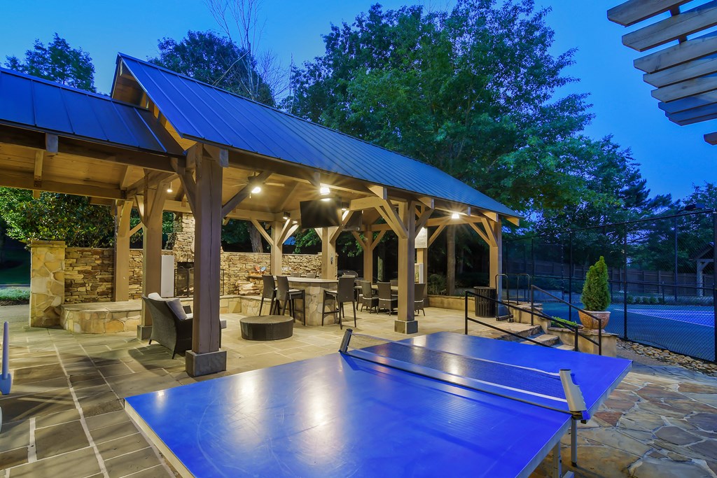 a backyard with a ping pong table and a pavilion with a pool at Lexington Pointe Apartment Homes in Oxford, 38655