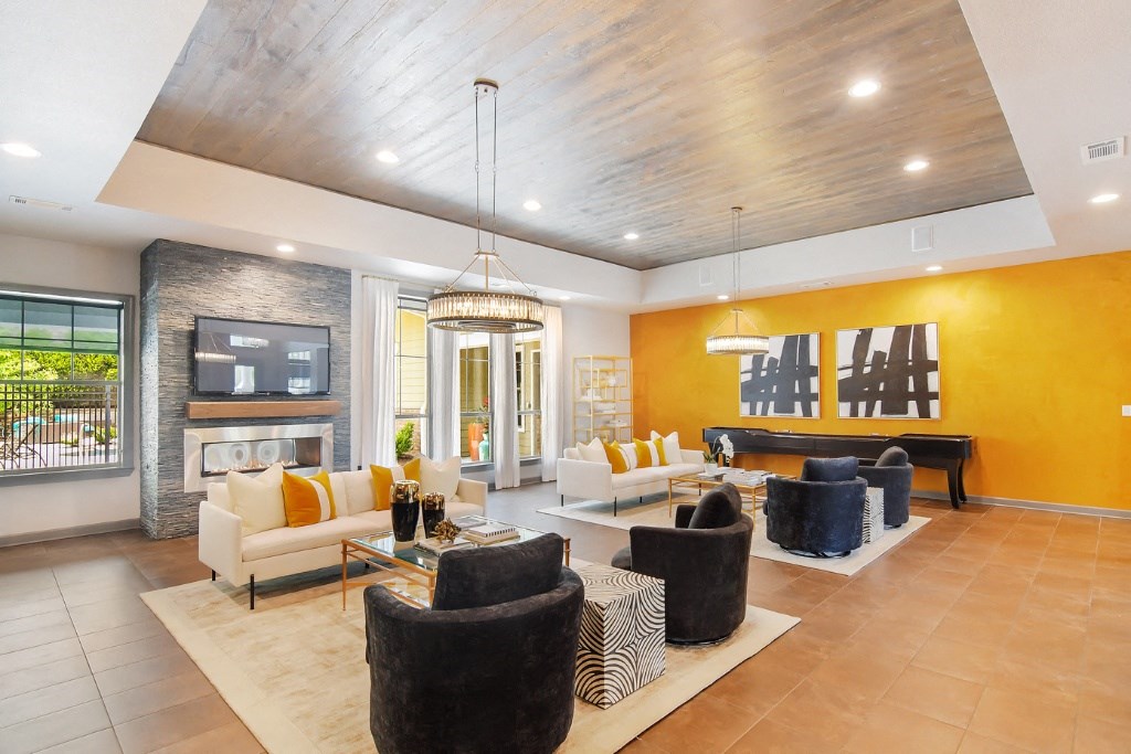 a living room filled with furniture and a fireplace at Faulkner Flats Apartment Homes, Oxford, MS
