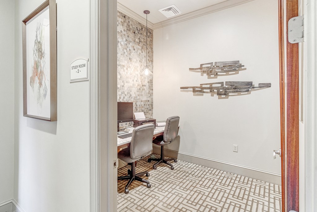 a dining room with a table and chairs and a wall with weapons on the wall at Cambridge Station Apartment Homes, Oxford, 38655