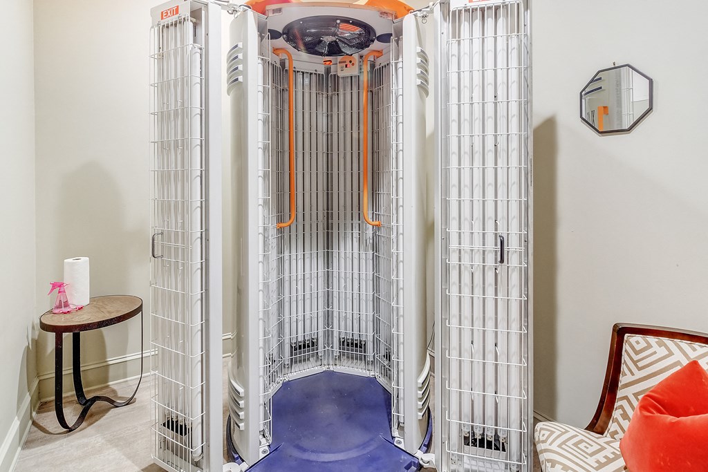 a set of cages in a room with a chair and a table at Cambridge Station Apartment Homes, Oxford, Mississippi