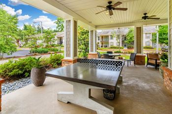 a covered patio with a ping pong table at Cambridge Station Apartment Homes, Oxford, MS, 38655