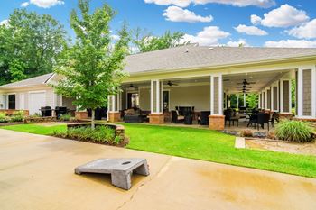 the view of a house with a patio and a lawn at Cambridge Station Apartment Homes, Mississippi