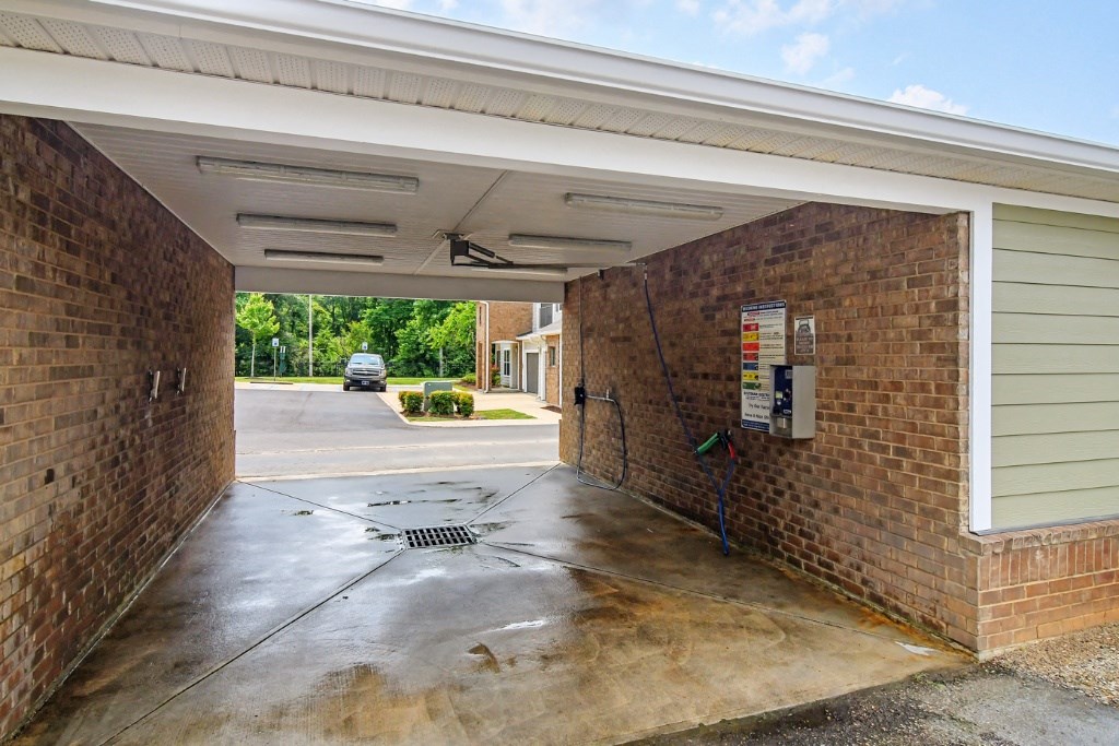a garage with a door open and a car parked in the distance at Faulkner Flats Apartment Homes, Oxford, 38655