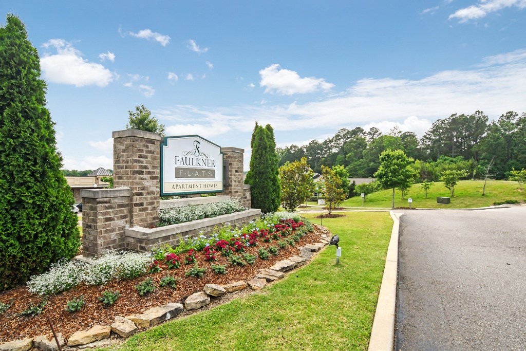 a sign for the fillmore country club sits in the middle of a grassy area with at Faulkner Flats Apartment Homes, Mississippi, 38655